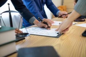 Businessmen and investors sign contract in front of company legal advisor and witness contract