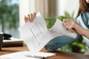 Close up portrait of a businesswoman hands breaking contract at office