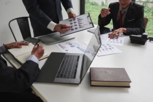 business consultant is advising businesspeople in conference room about investing in high risk projects