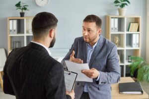Dissatisfied business people colleagues disputing having disagreement at workplace